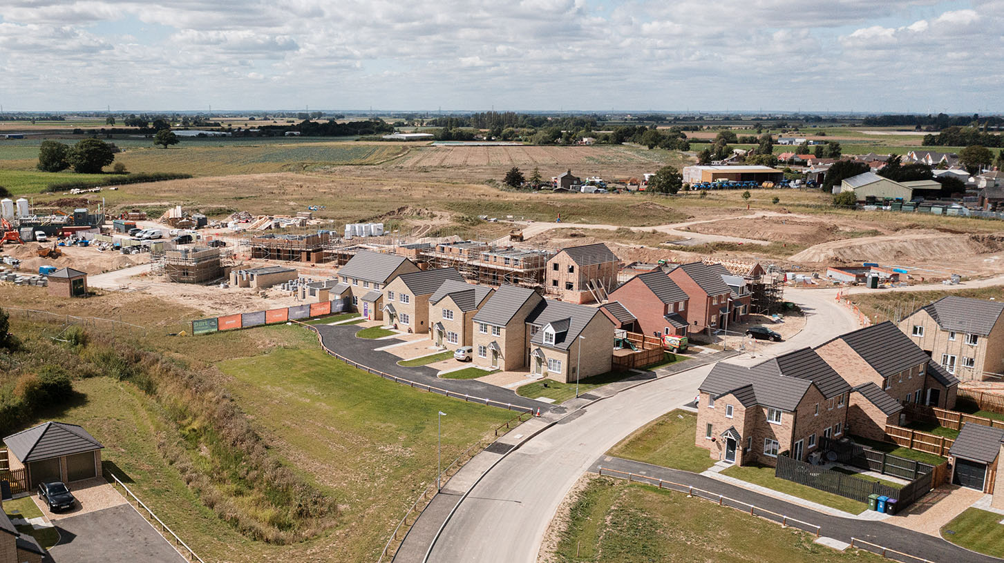 Building site drone shot with fields in the background